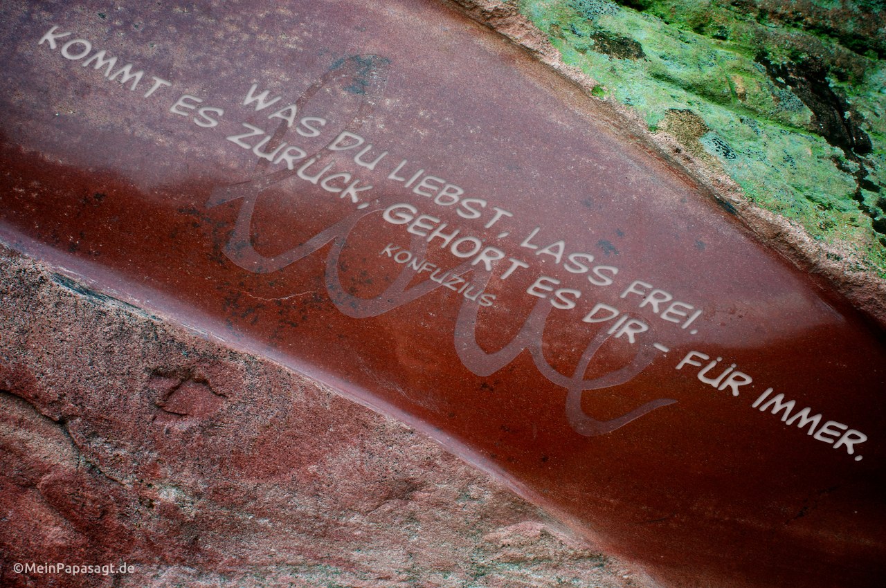 Schriftzug "Love" auf einem Stein, plus Grafik mit einem Konfuzius Zitat: Was du liebst, lass frei. Kommt es zurück, gehört es dir - für immer. Konfuzius